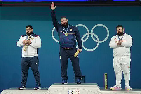 Paris Olympics men's +102kg weightlifting: Varazdat Lalayan of Armenia, silver, Lasha Talakhadze of Georgia, gold, and Gor Minasyan of Bahrain, bronze